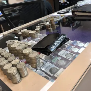 He stacks them neat &amp; tells you the value.
