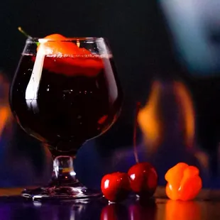 a glass of wine and cherries