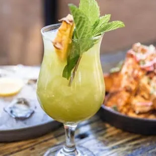 a glass of drink and a plate of food