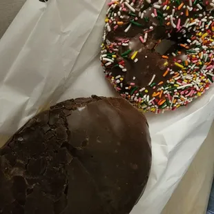 a chocolate frosted donut and a chocolate frosted donut