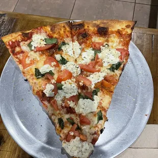 a slice of pizza on a plate