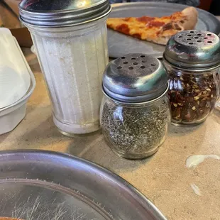 All the condiments you would need for your pizza and to your liking!