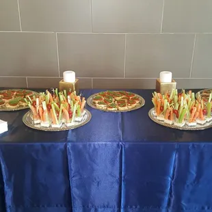 Veggie shot glasses served with carrots, celery and grape tomatoes.