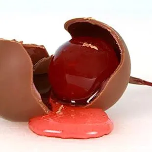 a broken chocolate egg with a pink substance