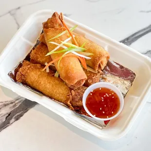 Crispy chicken and veggie egg rolls served with side of sweet chili sauce
