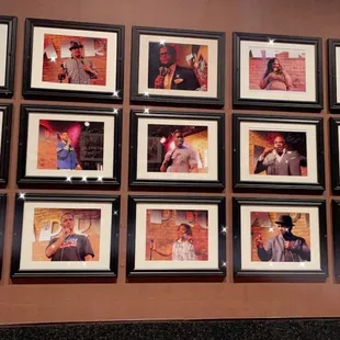 a wall of framed photos