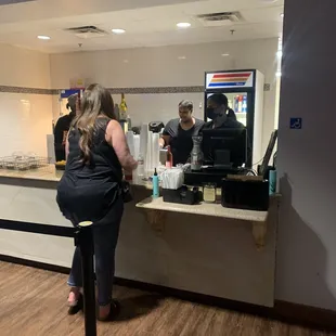 a woman standing at a counter