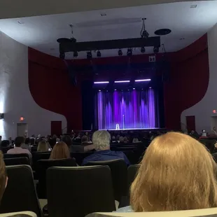 a stage with a purple curtain