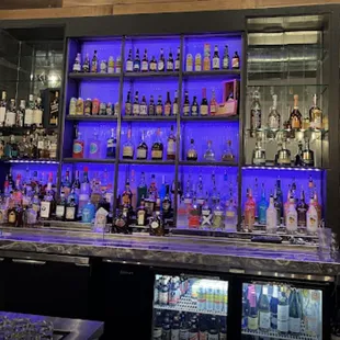 a bar with bottles of alcohol