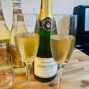two glasses of wine and a bottle of wine