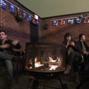 people sitting around a fire pit