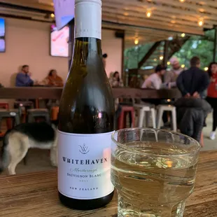 a bottle of white wine and a glass of water
