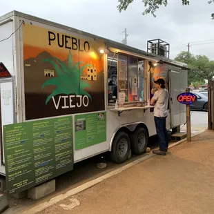 a man standing in front of a food truck