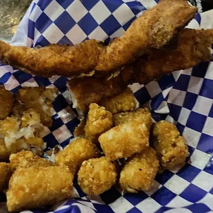 Greasy over fried chicken tender and cold greasy tots.