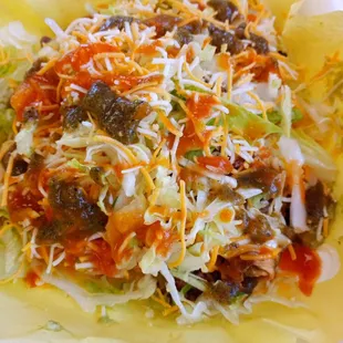 Super rolled tacos.  Shredded beef taquitos topped with carne asada, cheese, lettuce, guacamole and sour cream