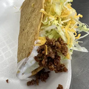 Ground beef hard shell taco   includes cheese  lettuce  sour cream