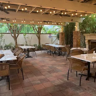 a patio with tables and chairs