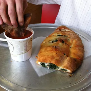 Gigantic spinach calzone - note the whole CUP of marinara that comes with it.