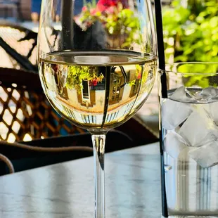 a glass of white wine and a glass of water