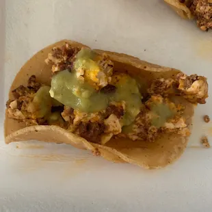 Close-up of Breakfast Taco w/ Corn Tortilla, Chorizo, and Green Sauce (Salsa Verde?).