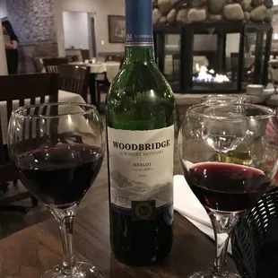 a bottle of wine and two glasses of wine