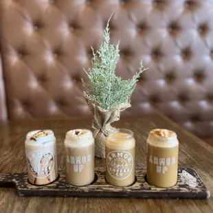 four different types of coffee on a tray