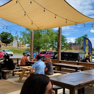 a group of people sitting at picnic tables