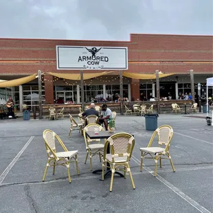 a man sitting at a table in a parking lot