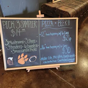 a chalk board with prices for pizza and beer