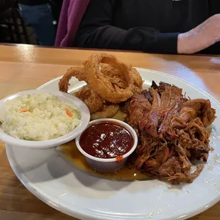 Pulled pork dinner with onion rings and Cole slaw