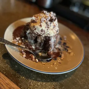June '22 dessert; House-made Chocolate Banana Bread with Vanilla Ice Cream, Chocolate Sauce, Candied Pecans topped with Powdered Sugar