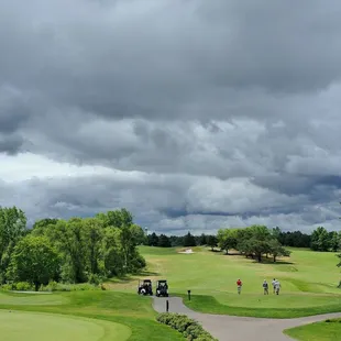 a golf course with a cloudy sky