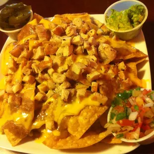 Half order of chicken nachos with condiments on the side.  Yum!