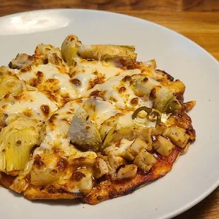 7" Jerk Pizza with grilled chicken, red and yellow peppers, pineapple, and artichokes with jerk sauce.