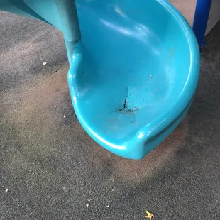 The bottom of the broken slide that hasn't been fixed for a while.