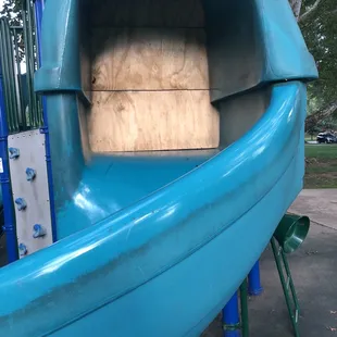 Plywood blocking a broken slide.