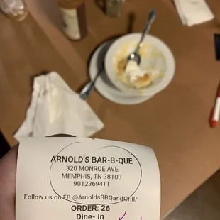 ows a hand holding a receipt