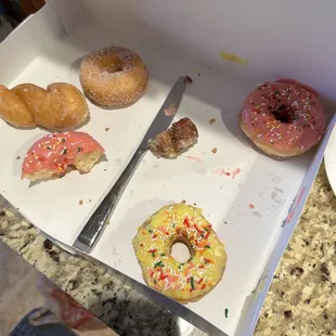 Mostly eaten assortment of doughnuts