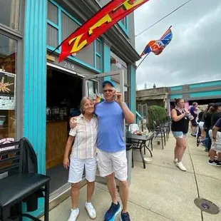 owner Arnold and bartender Patty delicious happy hour drinks afternoon sun fun cornhole darts live music