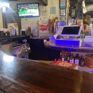 a bar counter with a laptop on it