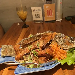 a plate of fried fish and salad