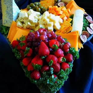 Cheese and Fruit Tray presented on marble, with Olives, Figs, Grapes, Strawberries.