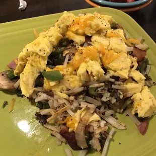 a plate of scrambled eggs and vegetables