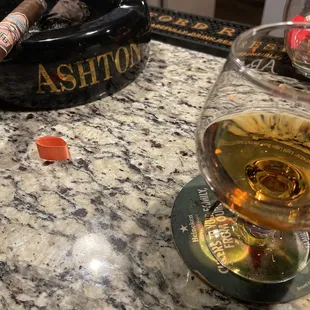a glass of alcohol and a cigar