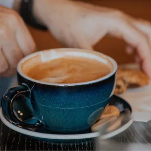 a person&apos;s hand reaching for a piece of bread