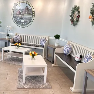 Cute corner towards the back. The pretty white wooden benches grabbed my attention.... Decorating ideas for my lanai. LOL.