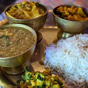 a plate of food with rice, beans, and vegetables