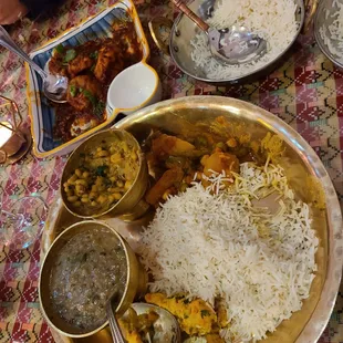a plate of food with rice and other dishes