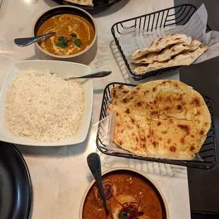 Chicken dish, vegetarian dish, naan, and gluten free bread