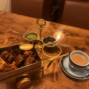 Goa fish curry, butter chicken, vegetable pakora, chai tea